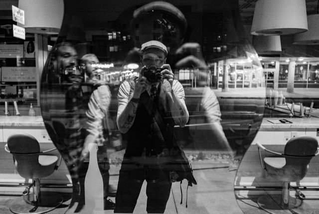 Jeff Tidwell - wedding photographer taking a photo of himself reflected in a window