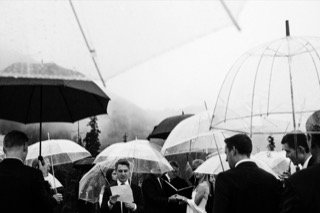 Ceremony: cage, catch, gathering, rain, stand, umbrella
