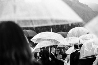 Ceremony: catch, crowd, gathering, rain, stand, umbrella