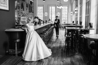 The Couple: bar, bar stool, bartender, wedding dress, bride, groom