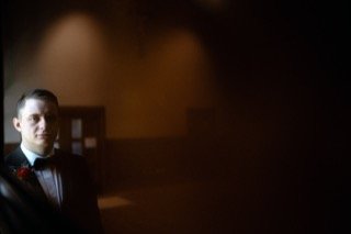 Getting Ready: bow tie, groom, cocktail dress, dark, doorway, room