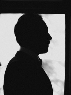 Getting Ready: profile, dark, shadow, stand, stare, tie