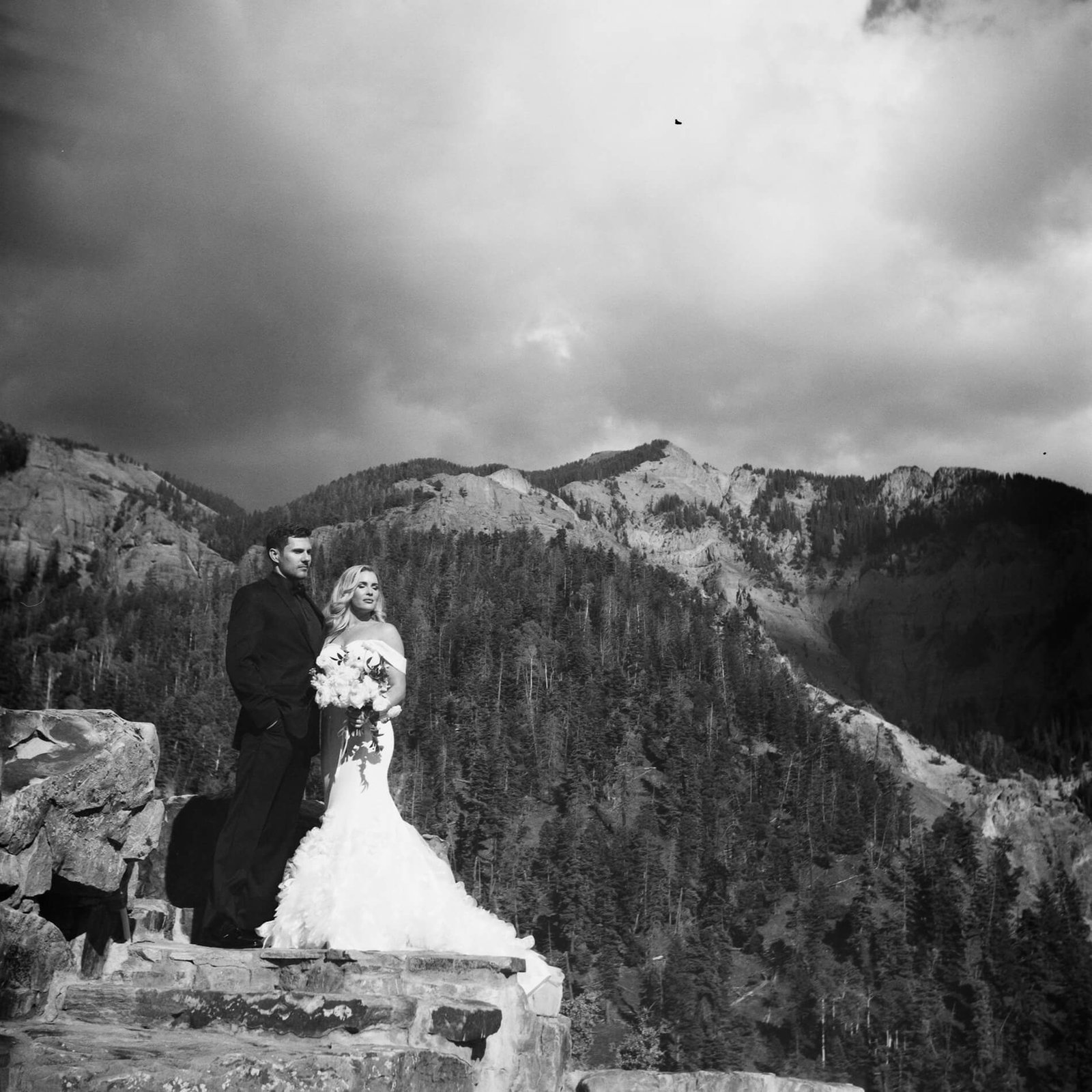 film shot of bride and groom with mountains in the background in Ouray, Colorado